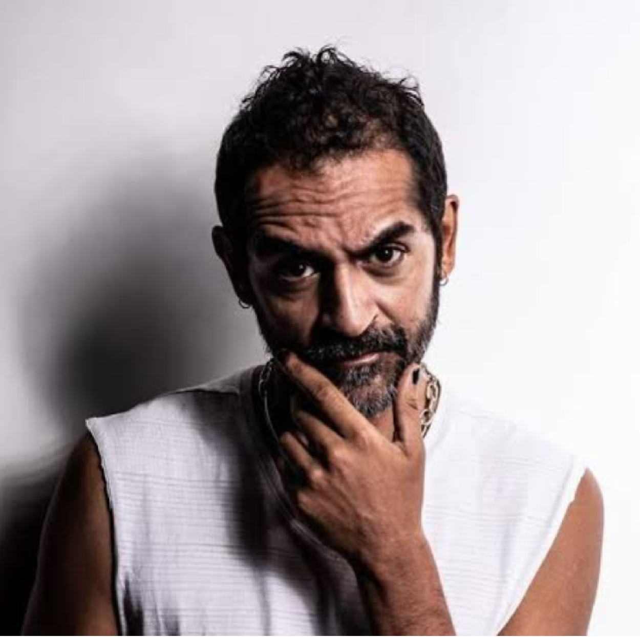 Karsh Kale performing live with tabla and electronic music setup under stage lights.